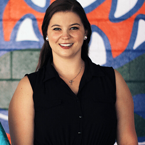 Portrait photo of Dr. Zaina DeLaney at the University of Florida football stadium.